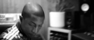 a black and white photo of a man in a recording studio