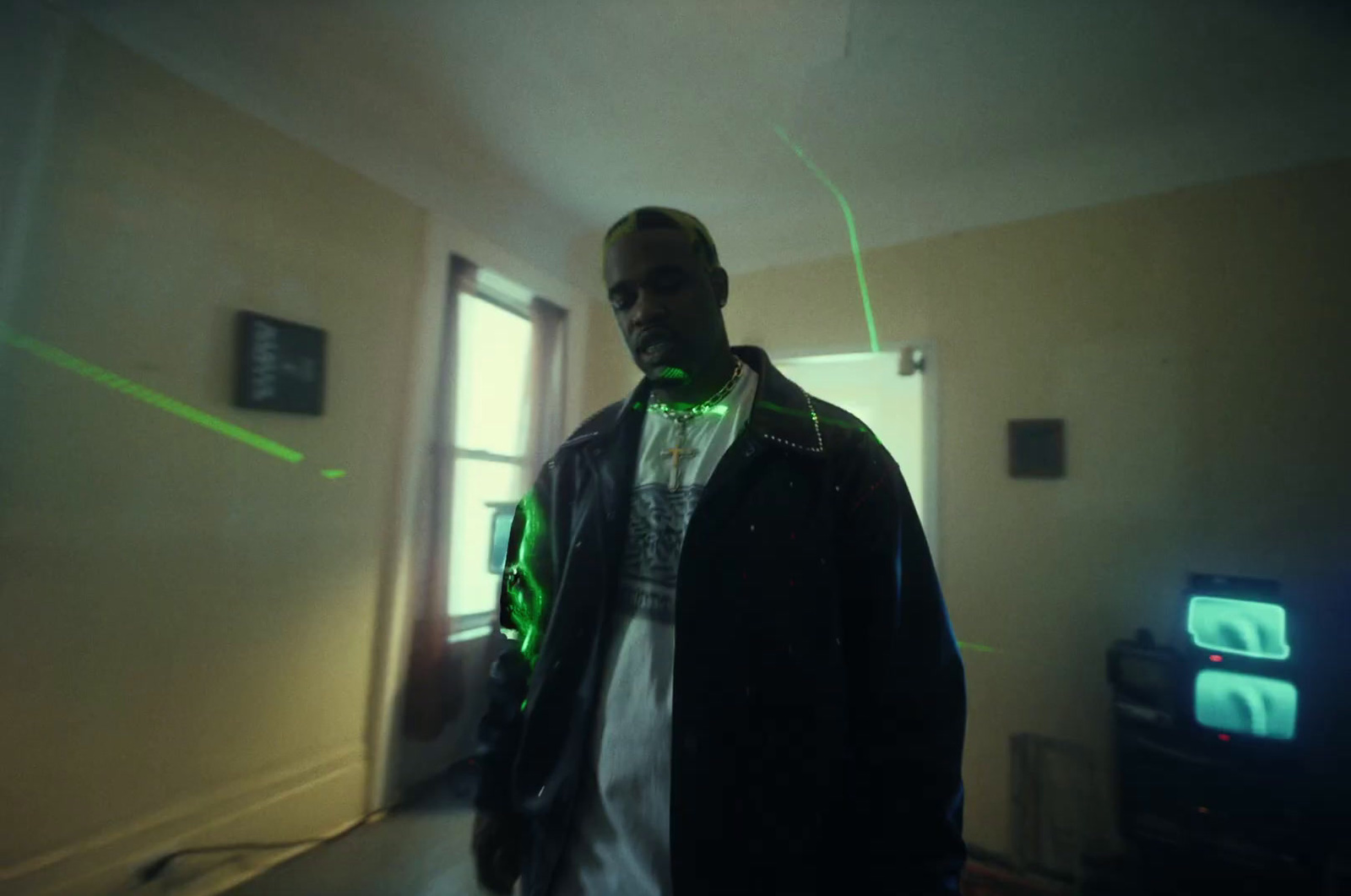 a man standing in a room with a green light