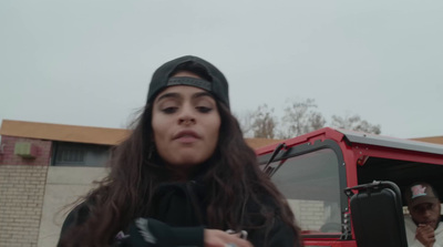 a woman standing in front of a red truck