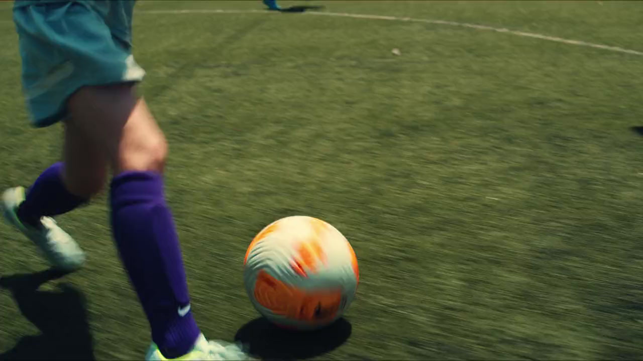 a close up of a person kicking a soccer ball