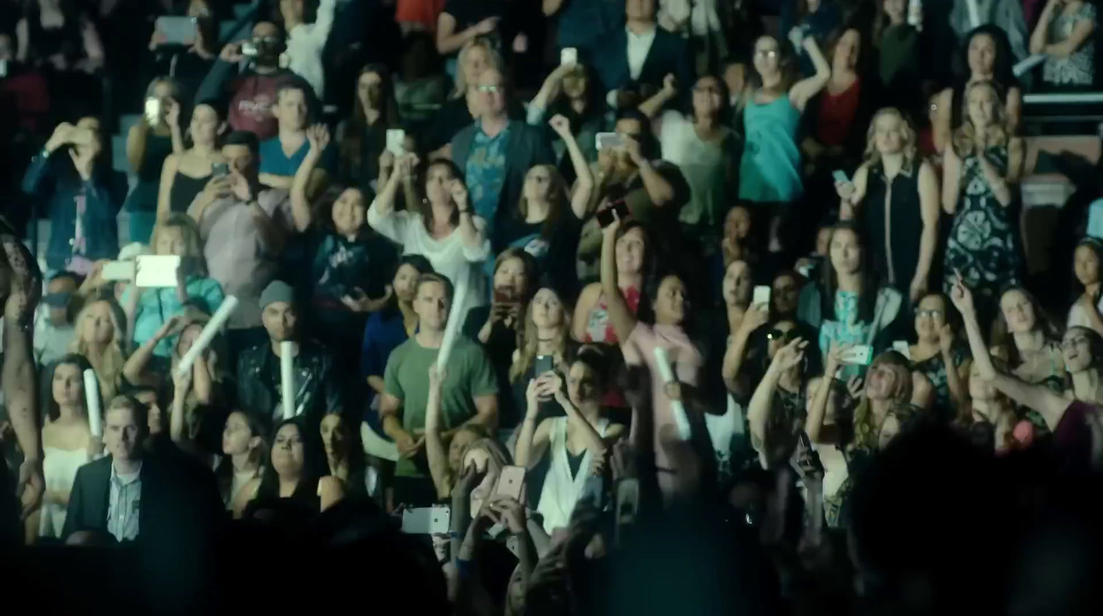 a large group of people standing in front of a crowd