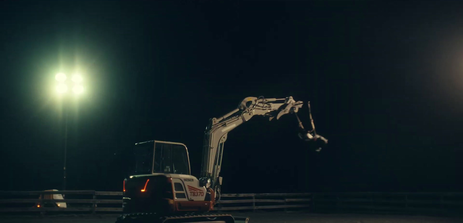 a construction vehicle parked in a parking lot at night