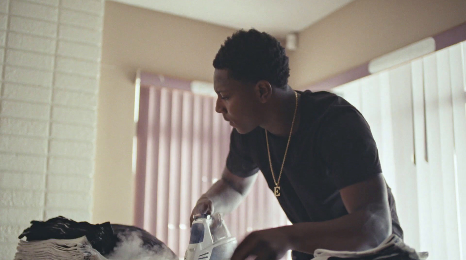 a man in a black shirt is washing his clothes