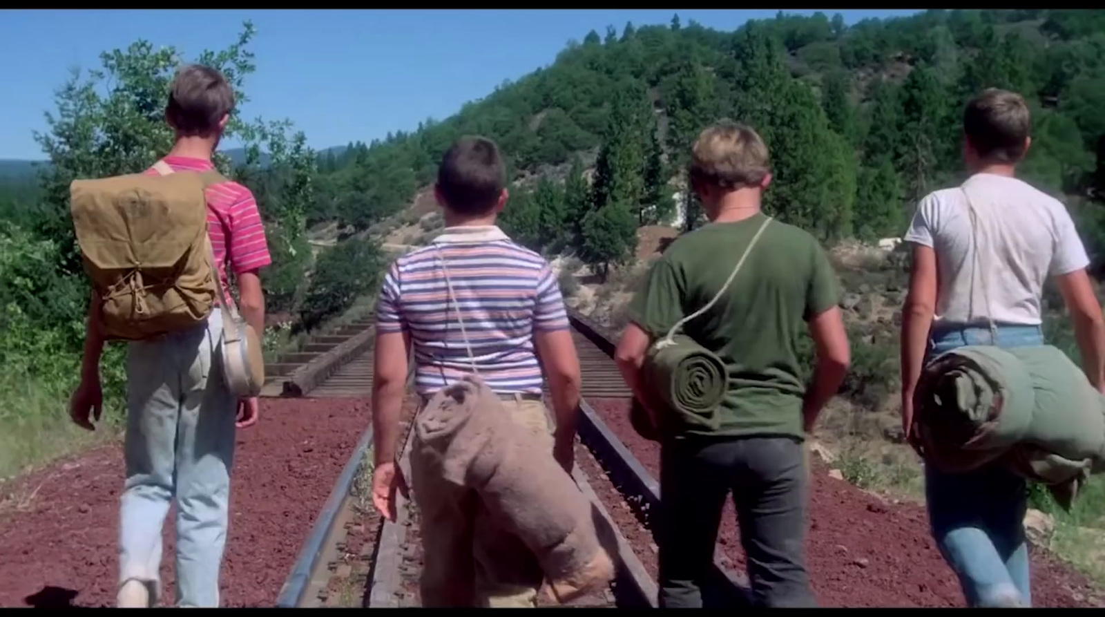 a group of people walking down a train track