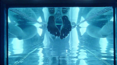 a person standing in a pool of water with their feet in the water