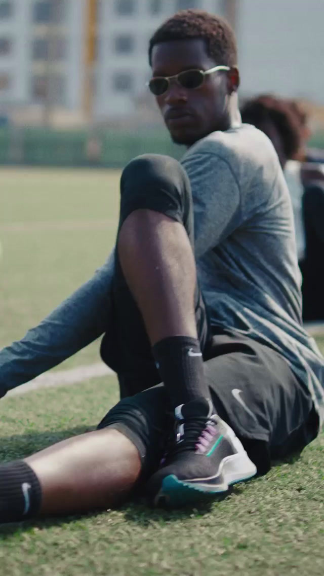 a man sitting on the ground with a soccer ball