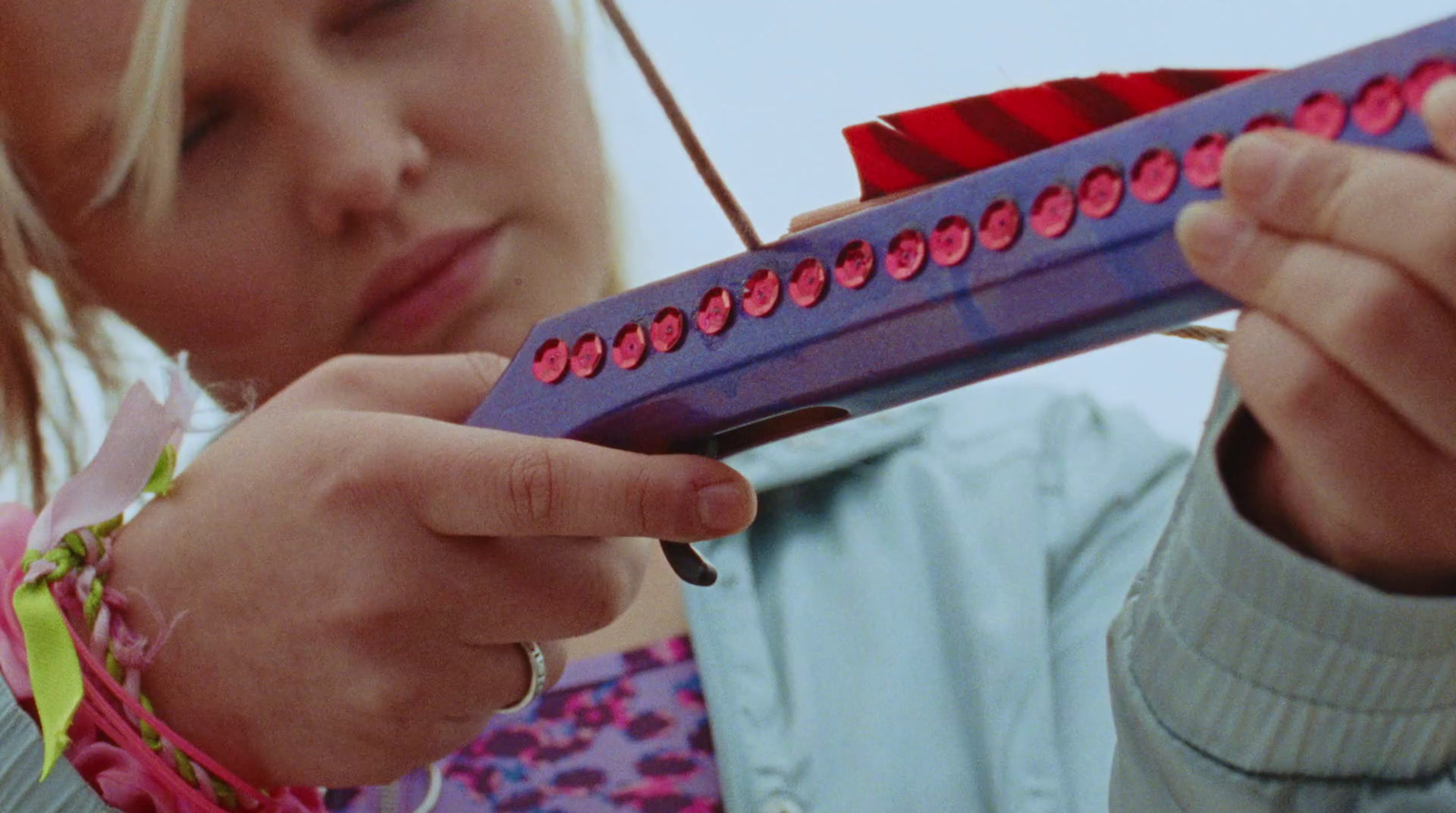 a little girl holding a purple toothbrush in her hand