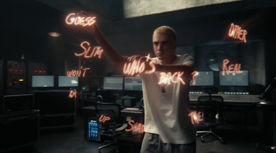 a man standing in a room with neon writing on the walls