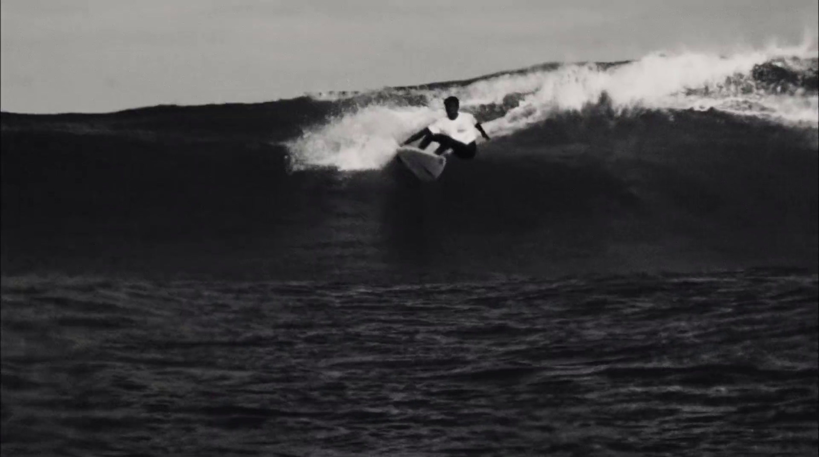 a man riding a wave on top of a surfboard