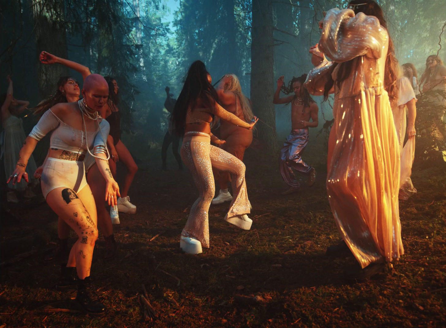 a group of women dancing in the woods