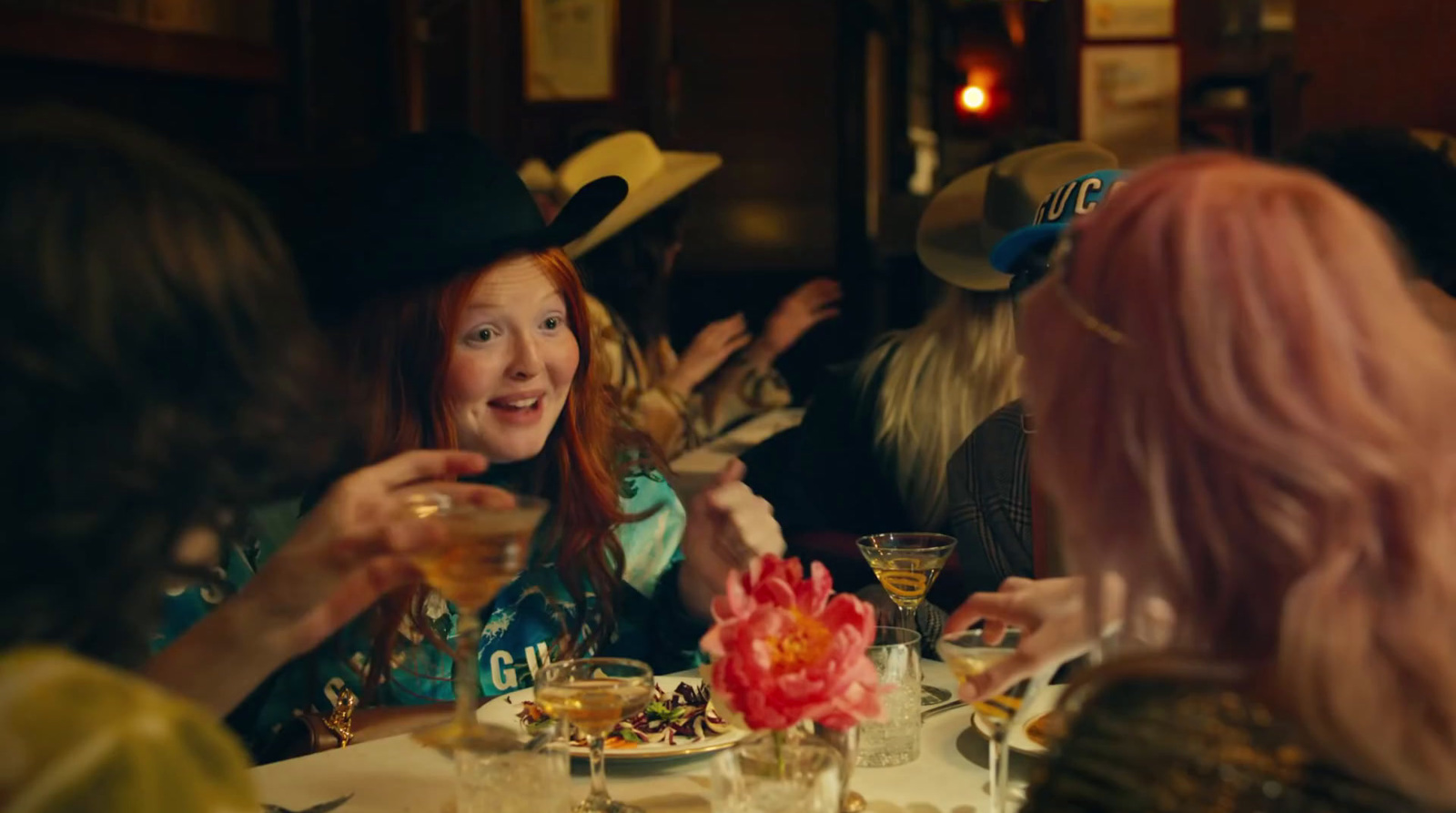 a group of women sitting at a table with drinks