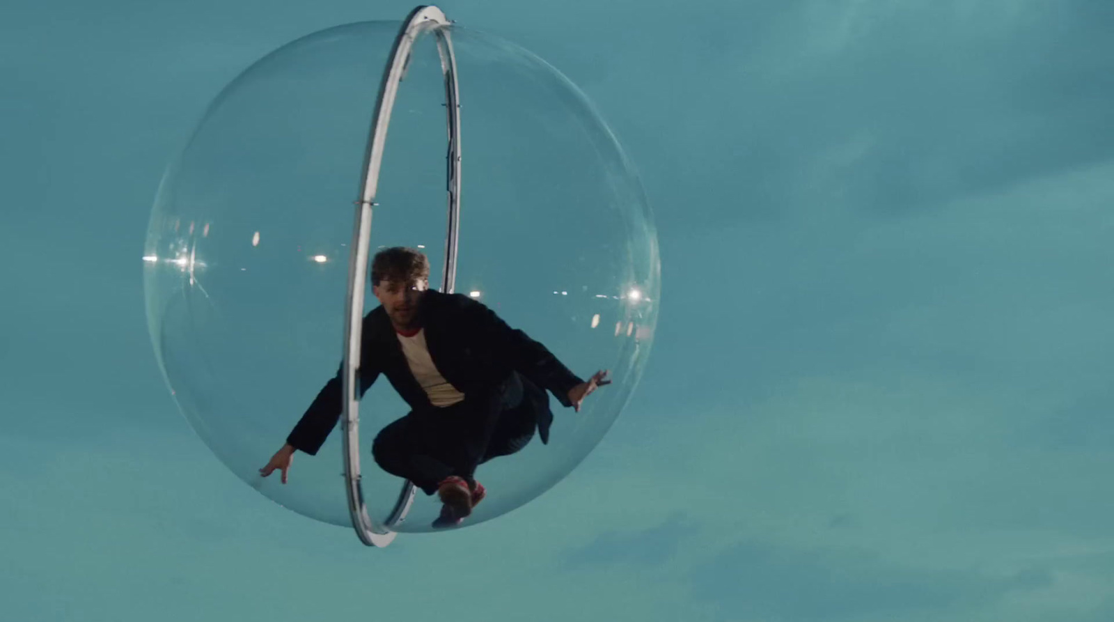 a man flying through the air through a bubble