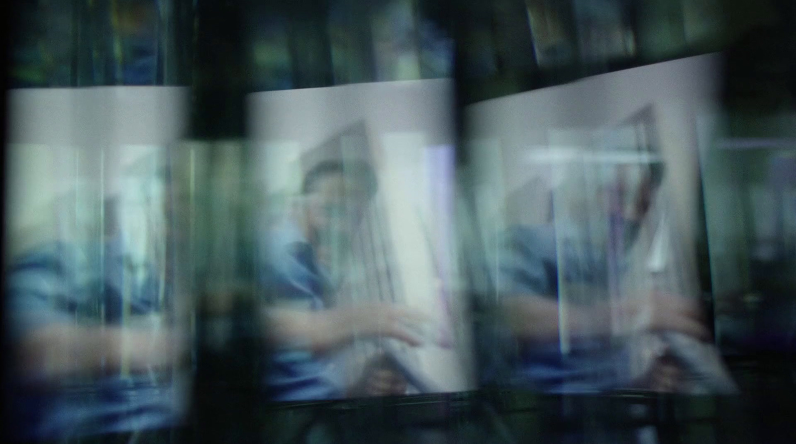 a blurry photo of a man sitting in a chair