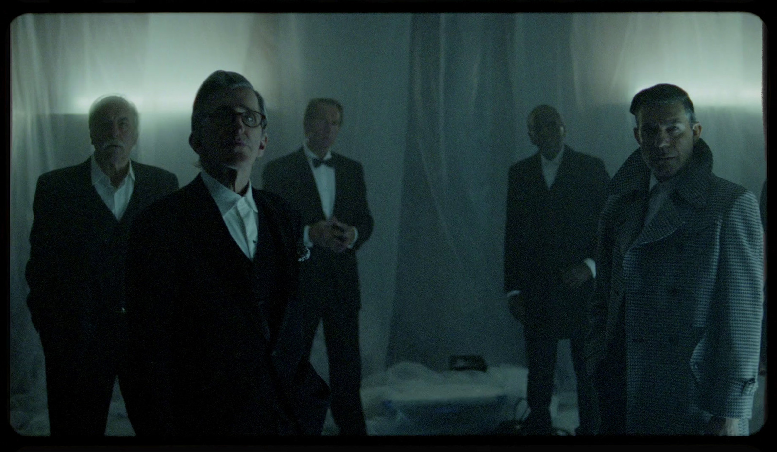 a group of men standing next to each other in a room