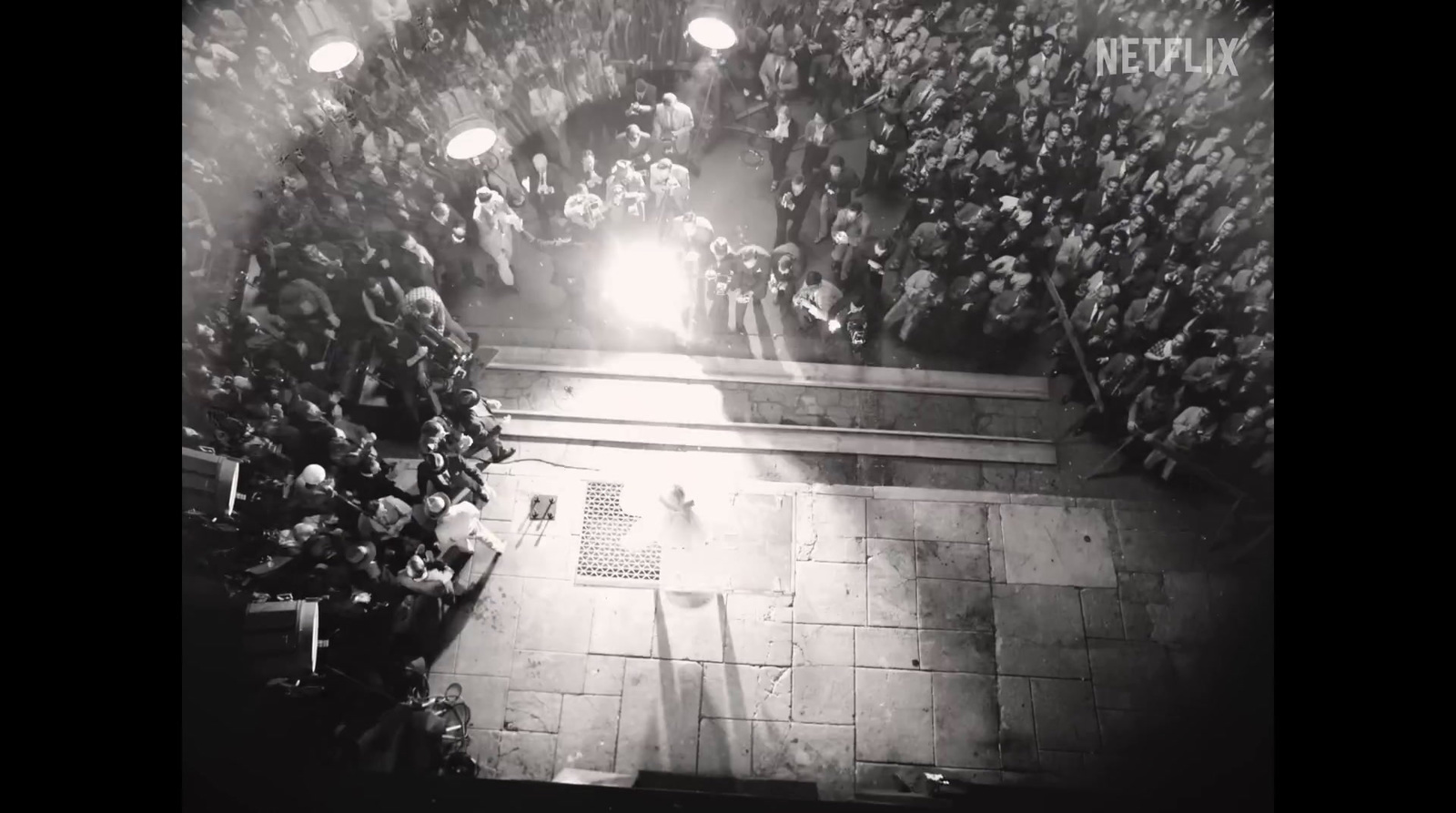 a crowd of people standing around a stage