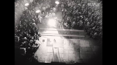 a crowd of people standing around a stage