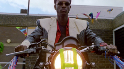 a man riding a motorcycle down a street