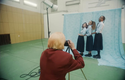 a woman taking a picture of a group of women