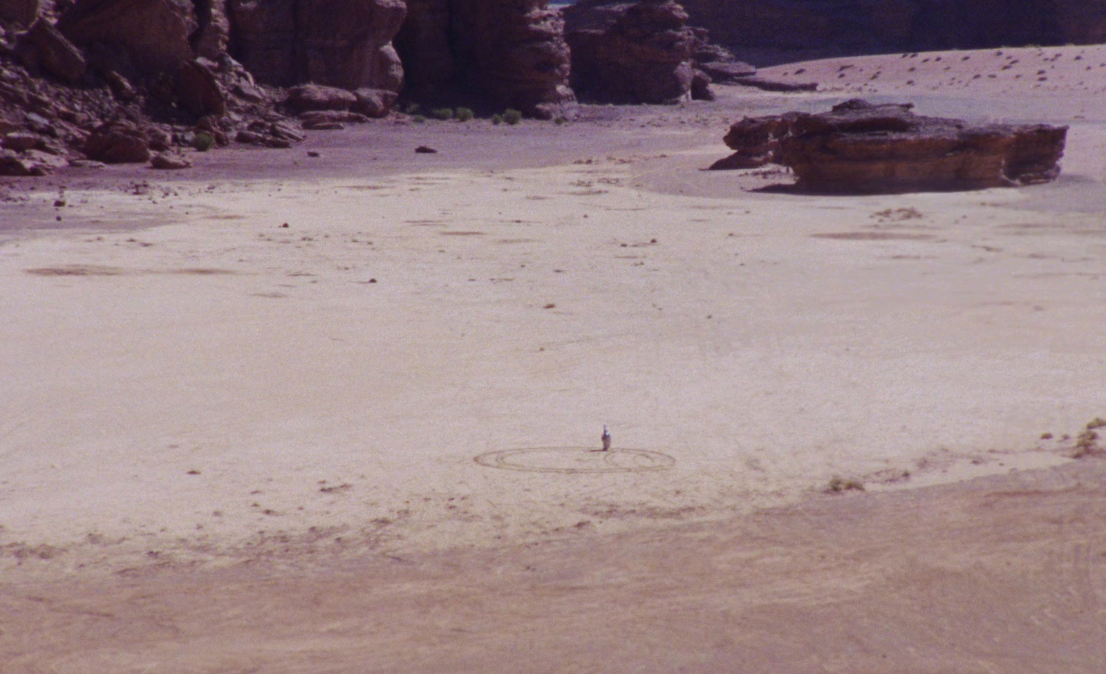 a man riding a horse on a sandy beach