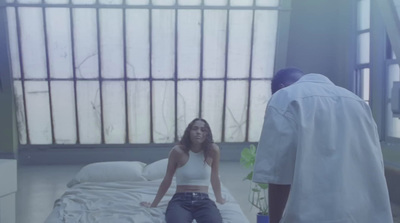 a woman sitting on a bed in a hospital room