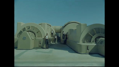 a group of people standing in front of a large machine