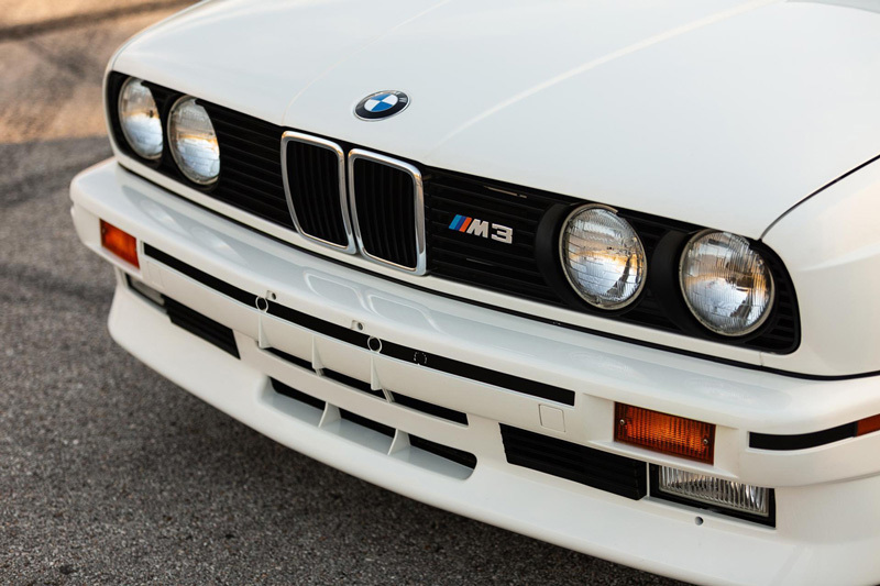 a close up of the front of a white car