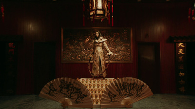 a statue of a woman holding a fan in a room