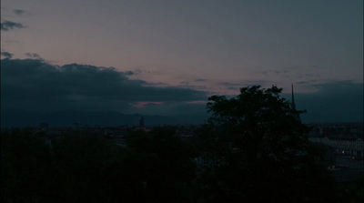 a view of a city from a hill at dusk