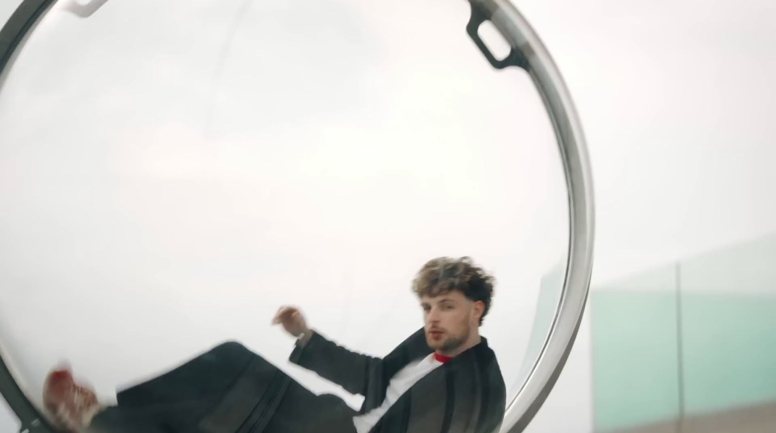 a man sitting in a chair in front of a mirror