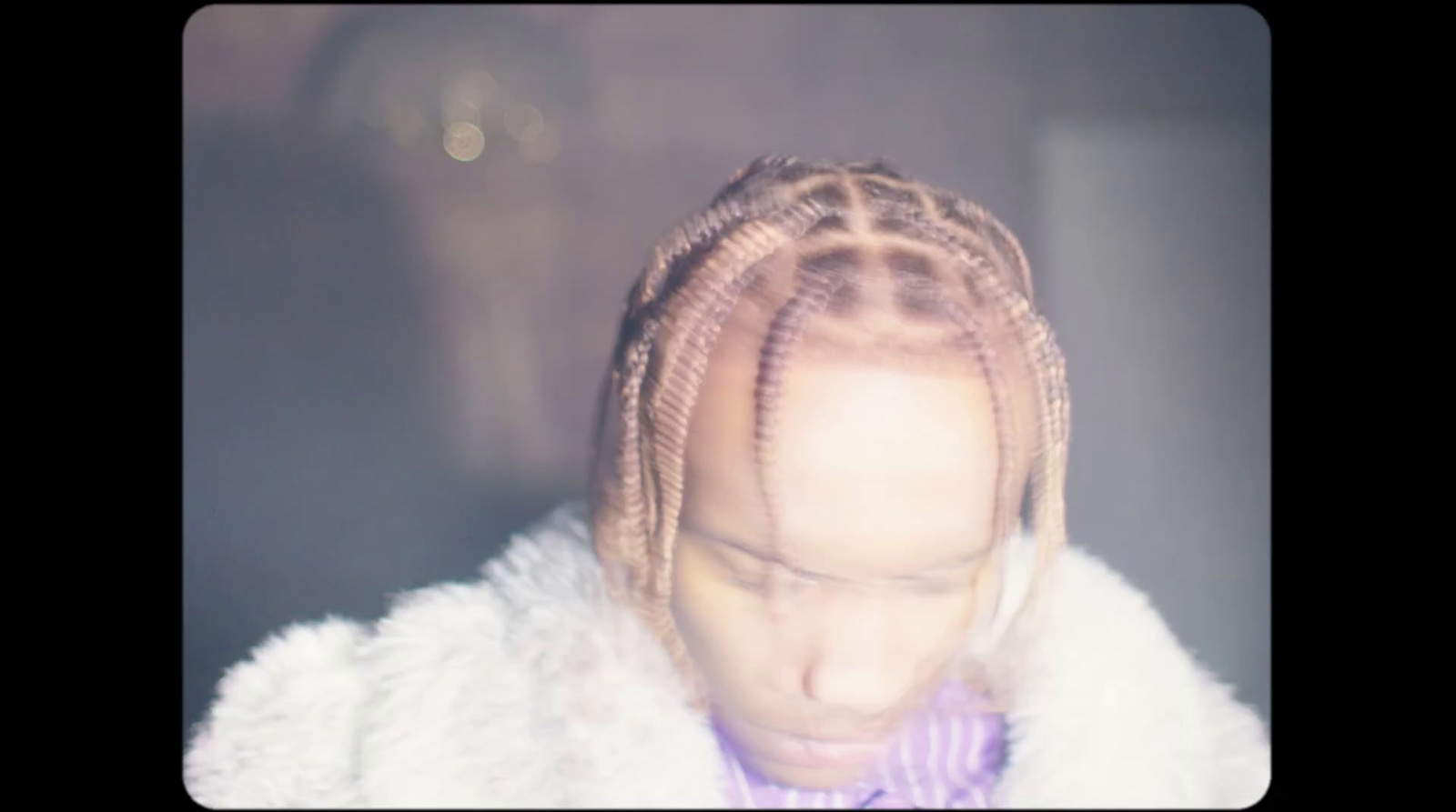 a woman with long box braids in a car