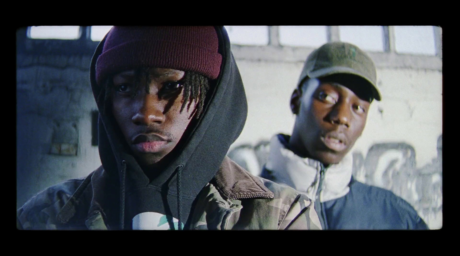 a couple of young men standing next to each other