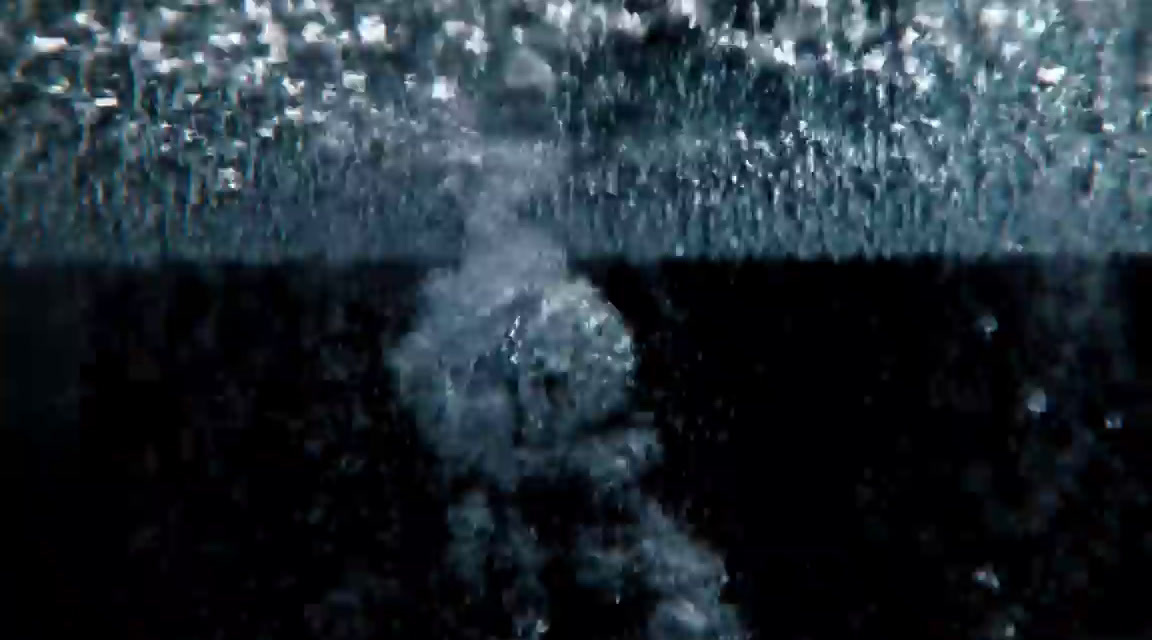 a blurry image of a person standing under water