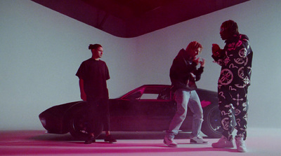 a group of people standing in front of a car