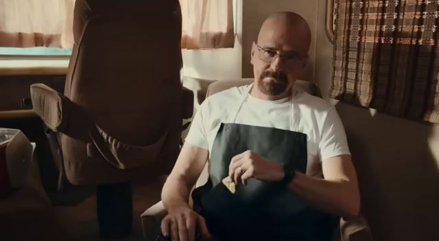 a man sitting in a chair holding a piece of paper