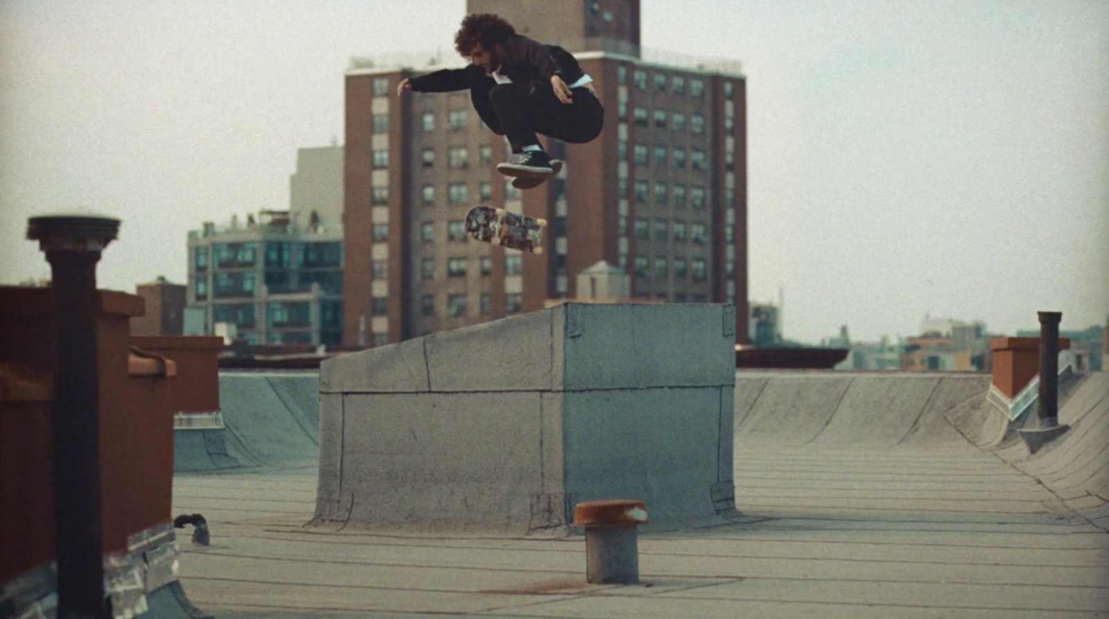 a man flying through the air while riding a skateboard