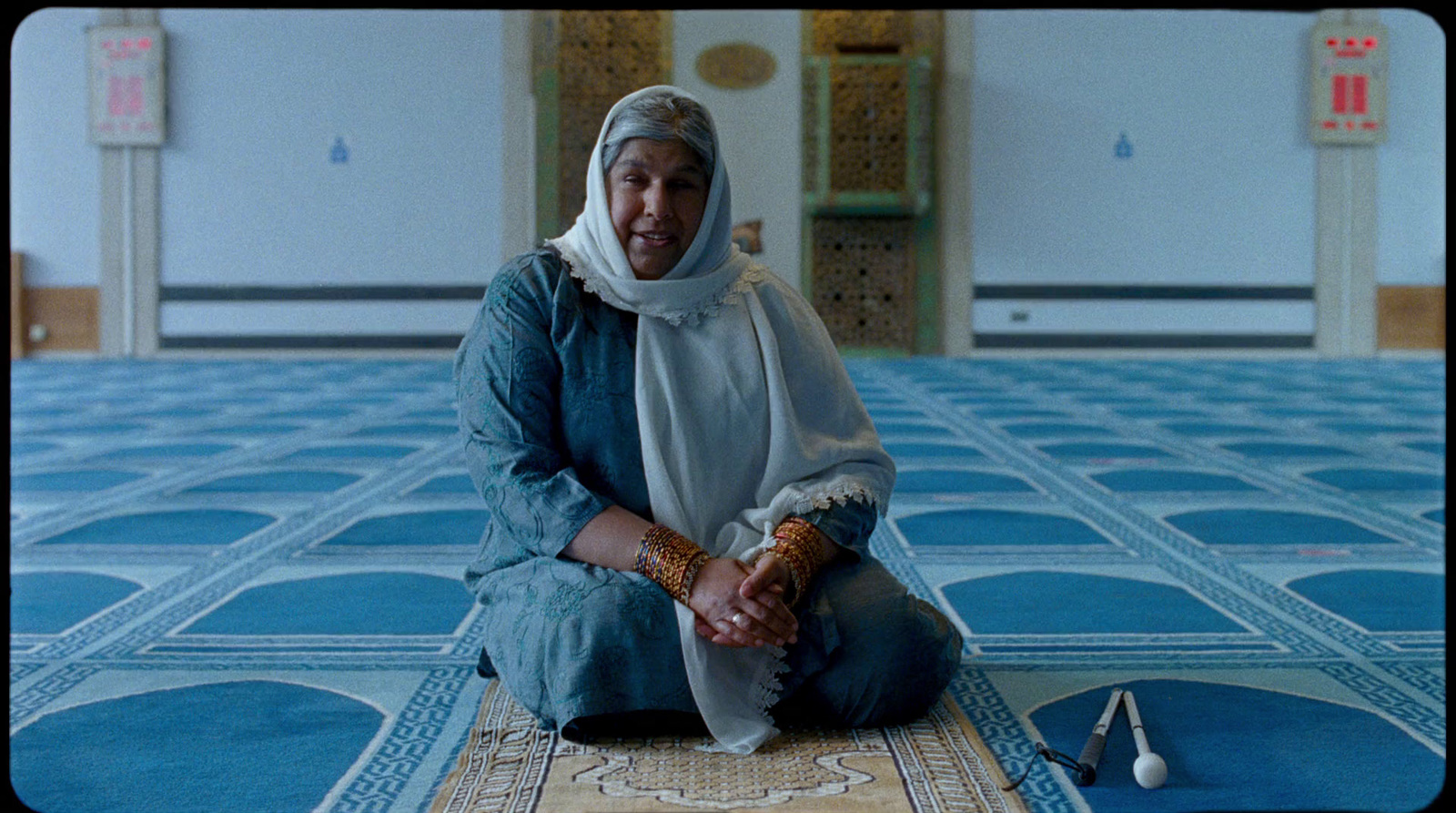 a man sitting on the floor of a mosque