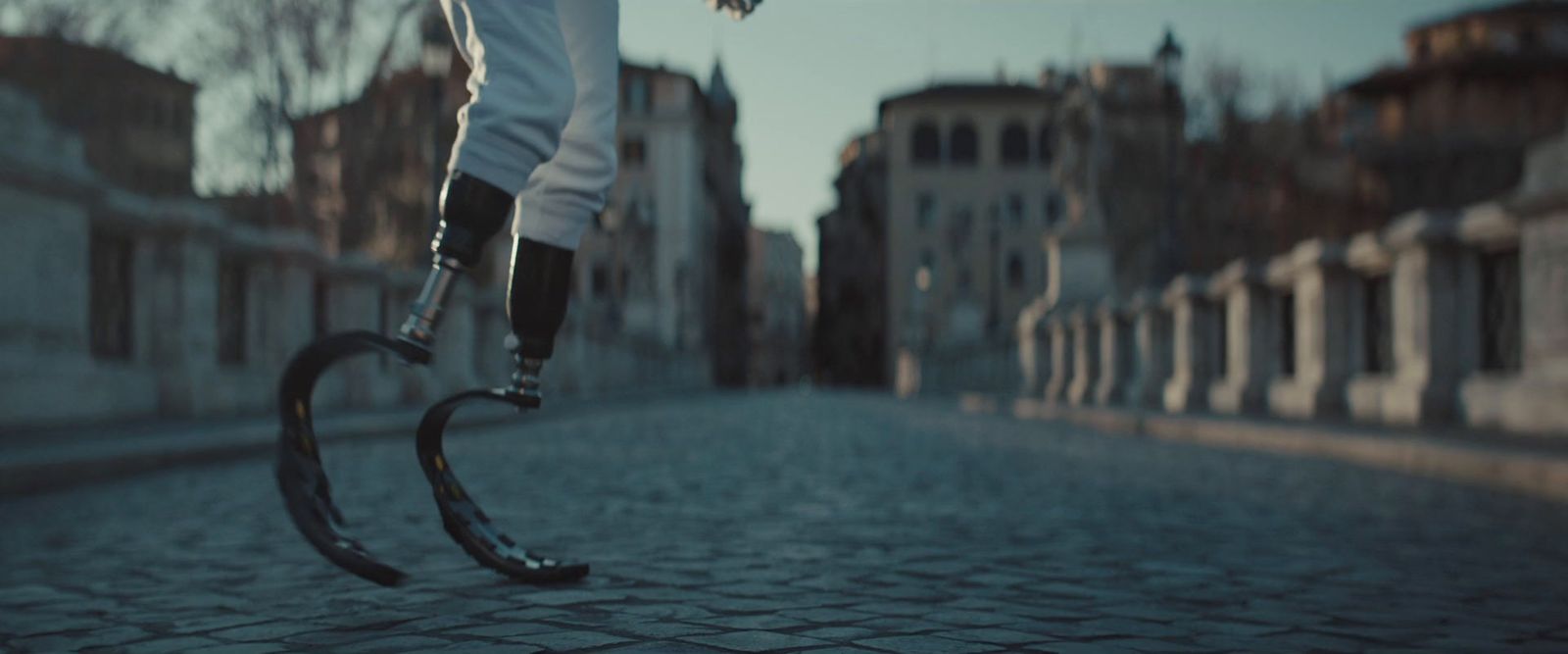 a person riding a scooter on a cobblestone street