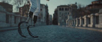 a person riding a scooter on a cobblestone street