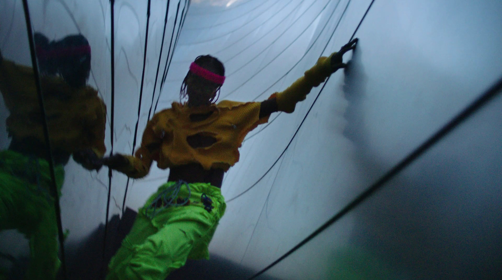 a man in a yellow shirt and green pants