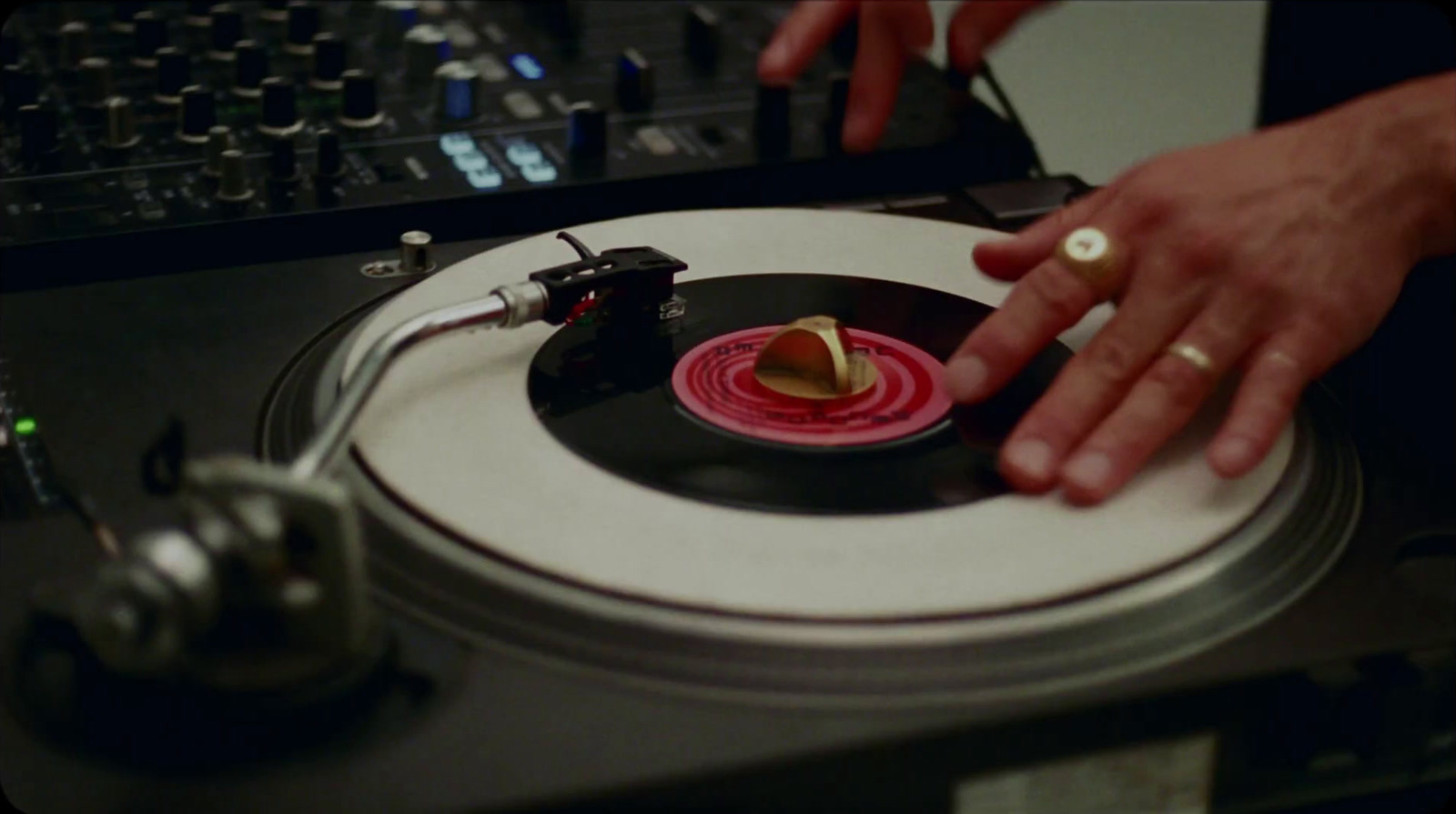 a person touching a record on a turntable