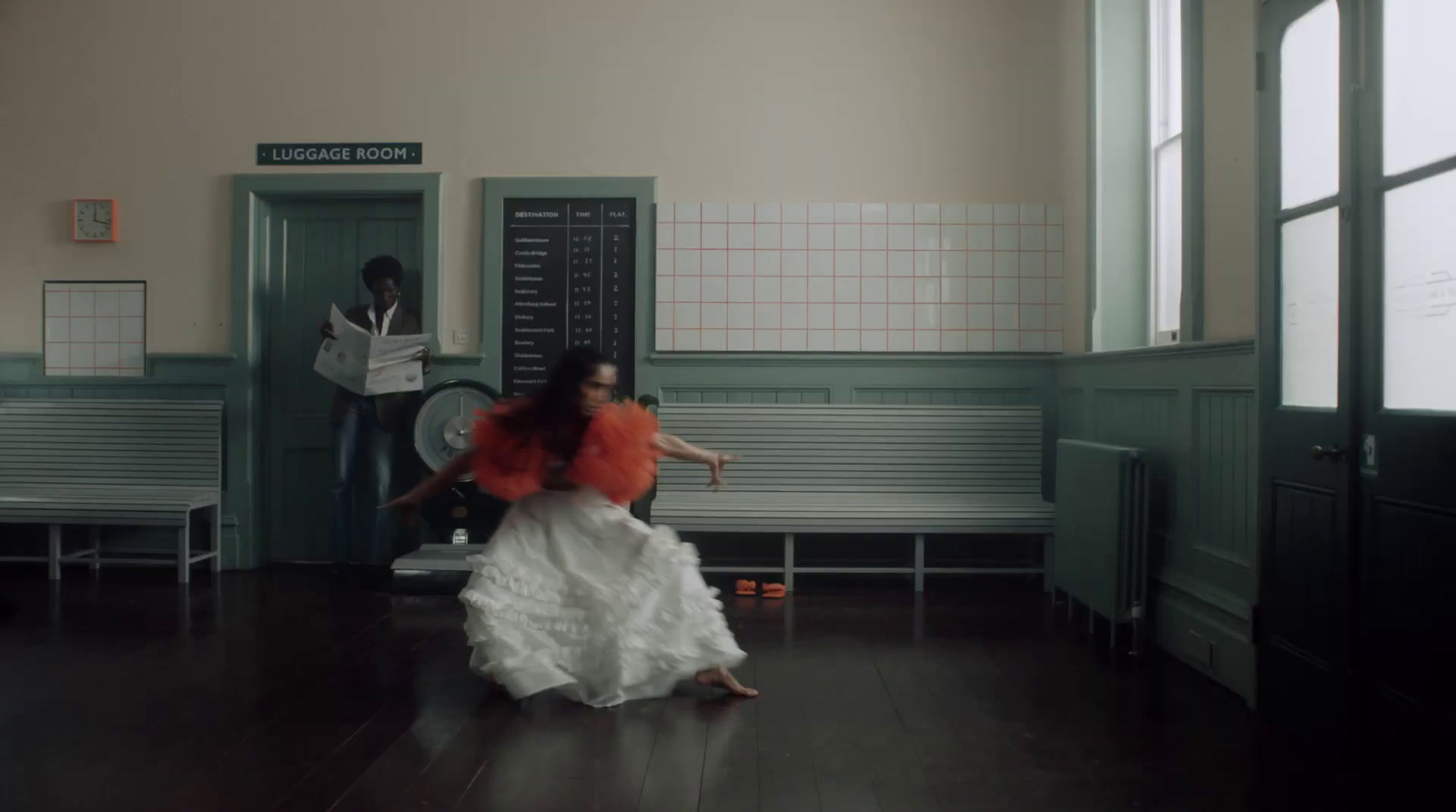 a woman in a white dress is dancing