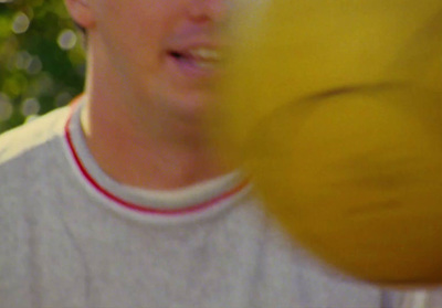 a man holding a yellow frisbee in his hand