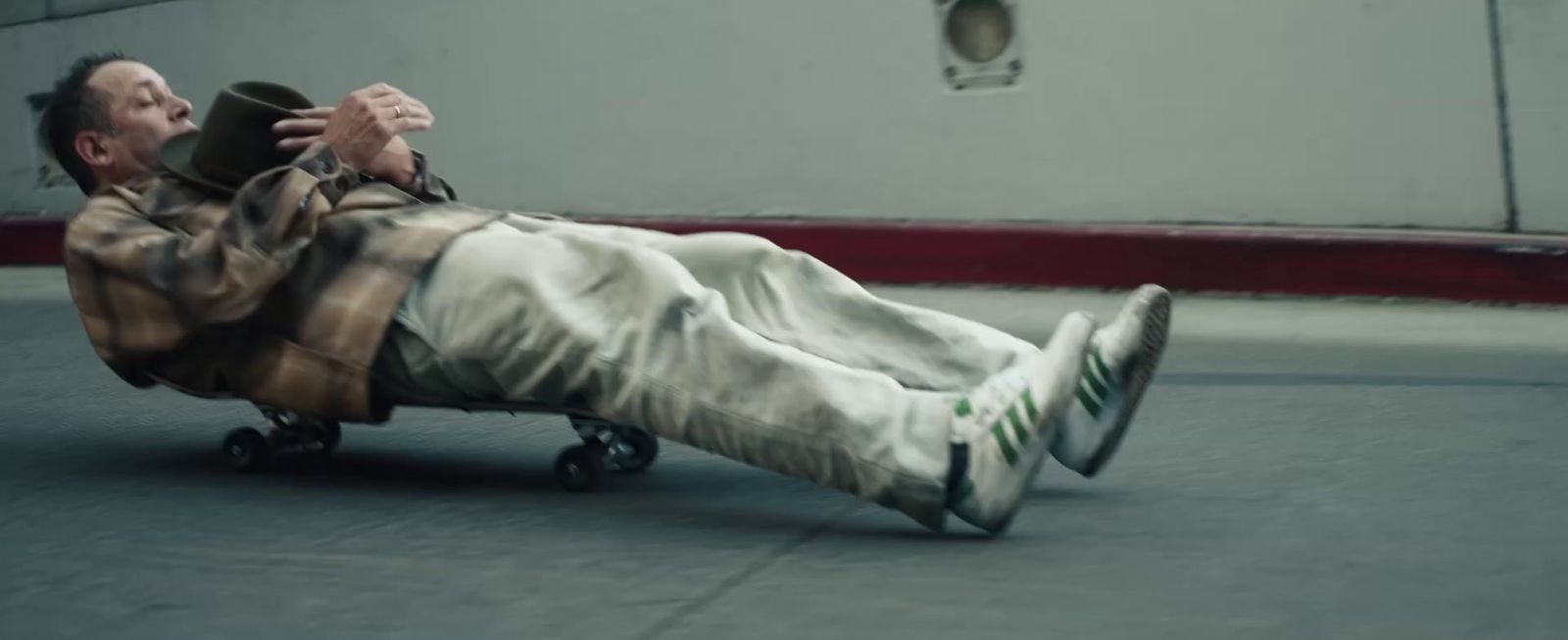 a man laying on the ground on a skateboard