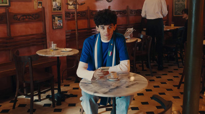 a man sitting at a table in a restaurant