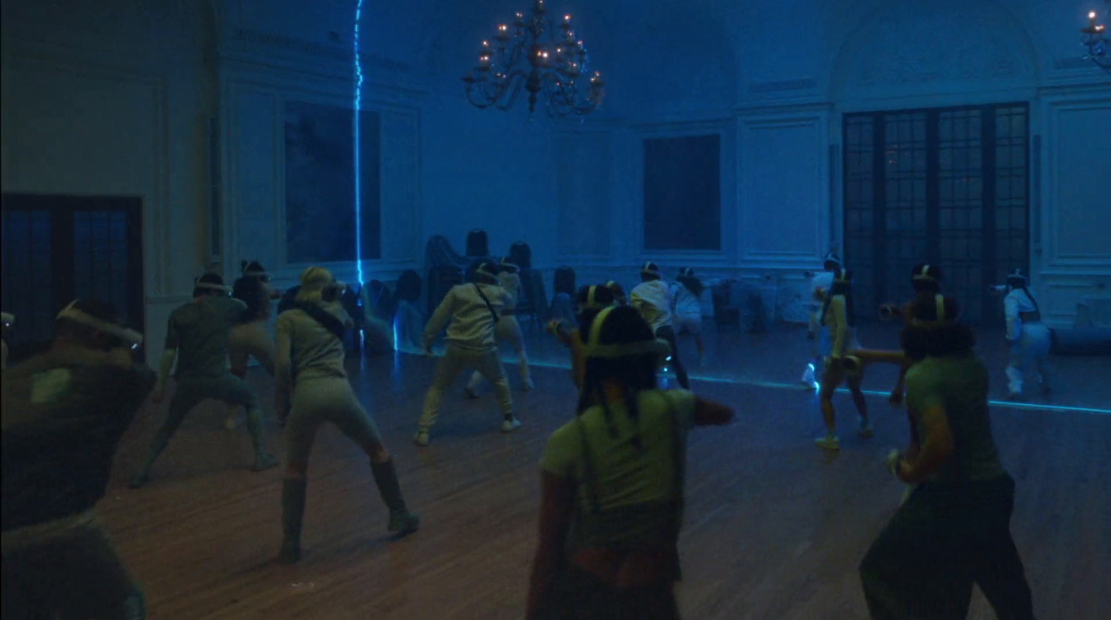 a group of people dancing in a dark room