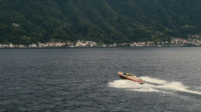 a speed boat speeding across a body of water