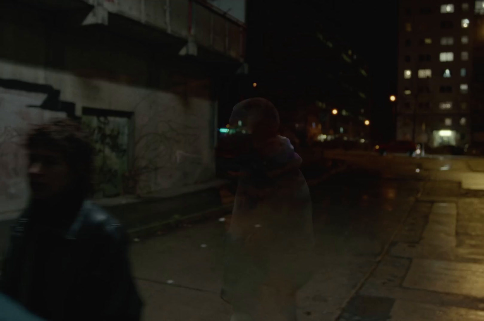 a man walking down a street at night