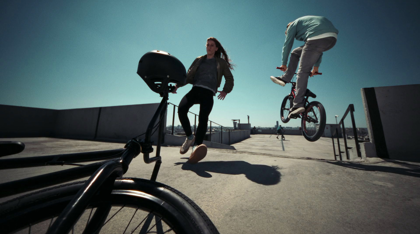 a couple of people riding bikes on top of a ramp