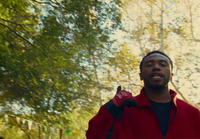 a man in a red jacket holding a red frisbee