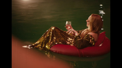 a woman sitting on a raft holding a glass of wine